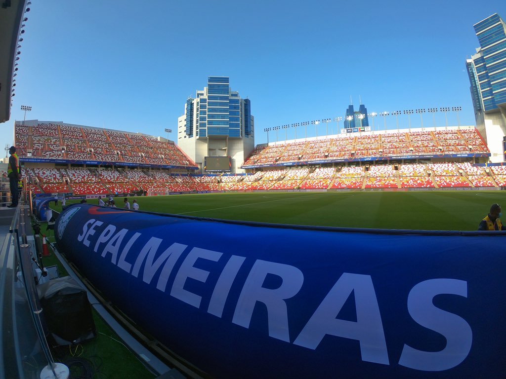 Faixa ao lado do campo mostra o nome do Palmeiras. Ao fundo, arquibancadas e o campo de futebol onde a final do mundial será disputada.