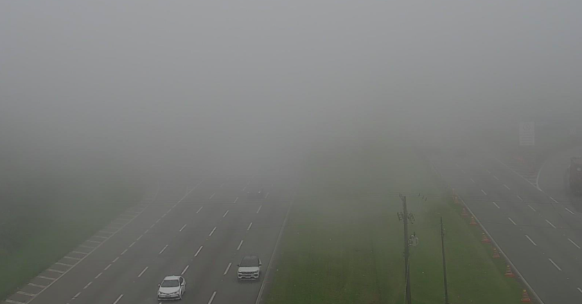 Foto mostra carros saindo do meio da neblina e fumaça impedindo visibilidade mais distante, cobrindo as duas pistas.